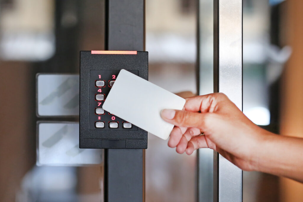 Key card held to a door access reader