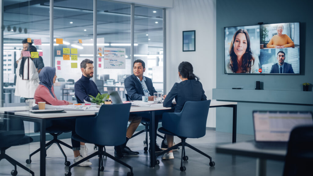 Team on a video conference call with a large wall display
